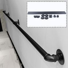 an image of a set of black handles on a white tiled wall with screws and bolts