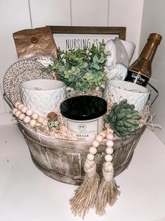 a basket filled with lots of different items on top of a white counter next to a bottle of wine