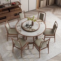 a round table with six chairs around it on a rug in the middle of a room