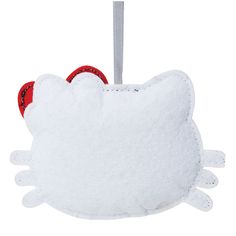 a white hello kitty ornament hanging from a red string on a white background