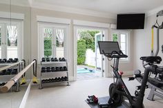 an exercise room with treadmills and other equipment