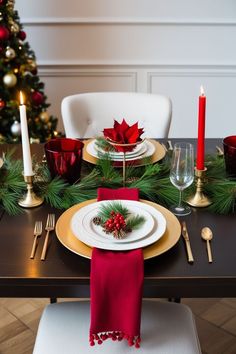 a christmas table setting with red and gold place settings