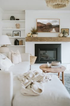 a living room filled with furniture and a fire place in front of a painting on the wall