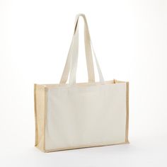 a white canvas bag on a white background with the handles down and one side open