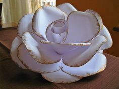 a white flower sitting on top of a table