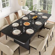 a dining room table set with plates and silverware