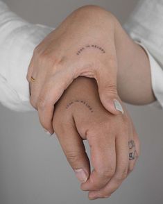 a woman's hand with the word love written on her left wrist and an arrow tattoo