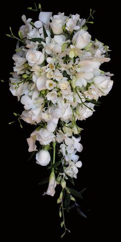 a bouquet of white flowers on a black background