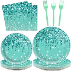 a set of four dinnerware with blue and white sparkles on it, including forks, spoons, and napkins