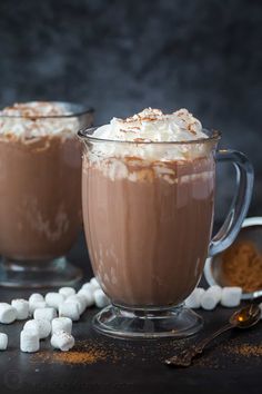 two glasses filled with hot chocolate and marshmallows