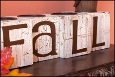 two wooden blocks with the word fall painted on them