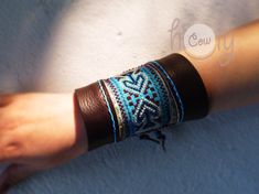 This hippie bracelet is 100% handmade from the finest quality brown leather. It is beautifully designed with vintage Hmong fabric on the front. No sewing machines or assembly lines are in sight. The Hmong tribe are an ethnic hill tribe group which lived near me in the mountains in the north of Thailand. The fabric insert used in this bracelet is Hmong vintage tribal tapestry which is beautifully cross stitched. An enormous amount of care and energy goes into making each bracelet. It has beautifu Hmong Fabric, Hippie Bracelet, Womens Bracelet, Hippie Bracelets, Bracelet Boho, Sewing Machines, Womens Bracelets, Leather Bracelet, Cuff Bracelets