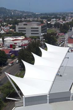 an aerial view of the roof of a building with white awnings on it