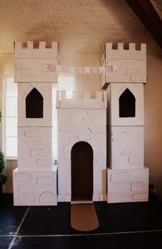 a castle made out of cardboard sitting on top of a floor