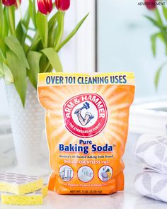 a bag of baking soda sitting on top of a counter next to a potted plant