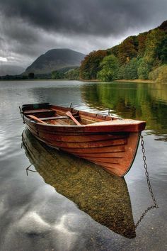 a small boat floating on top of a lake