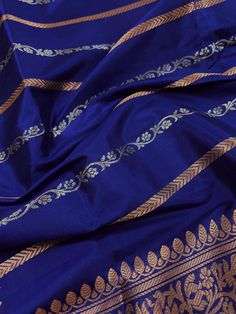 SILK MARK CERTIFIED !!Gorgeous Pure KatanSilk Blue Color with Copper and Slier Zari Work. Strips Sarees in Copper and Sliver Zari with Floral Buttas on the Pallu Soft, light weight and easy to drape Saree. The Strips are dense towards the pallu and get scattered the other end. Item : SareeColor : Blue ColorBase Fabric : Pure Katan Silk Blouse piece : Comes with Blouse pieceBlouse material : Pure Katan SilkFall & Edging (Yes/No) : YesComes with Silk Mark Certificate (Yes/No) : Yes Disclaimer -:- Blue Silk Anarkali Set With Pallu, Blue Anarkali Set With Pallu In Raw Silk, Blue Katan Silk Traditional Wear For Festive Occasions, Blue Katan Silk Salwar Kameez For Eid, Blue Katan Silk Kurta For Wedding, Blue Raw Silk Salwar Kameez With Pallu, Blue Katan Silk Sets With Dupatta, Blue Anarkali In Katan Silk, Festive Blue Katan Silk Kurta