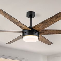 a ceiling fan with wooden blades and light fixture in a living room or dining room