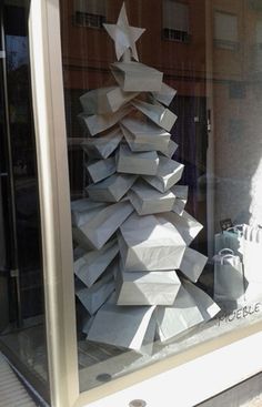 an image of a christmas tree made out of boxes in a store window with the caption'visit verizon lite '