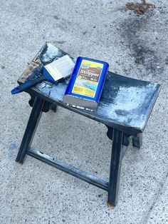 a book sitting on top of a wooden table next to a pair of blue scissors