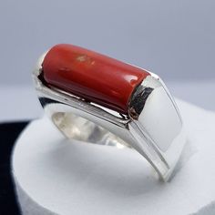 "Red Coral /Moonga 4.00-11.00 Ct. Stone 92.5 Sterling Silver Ring For Men & Women. This ring is suitable for Men & Women having ring sizes between 4.25 to 12.00 as per US ring standards. Size of this ring is easily by hand. Fine quality Red Coral is used to give best results for your astrological needs. Stone will be neat and clean without blemishes. Gemstone is left open from the back side. Gemstone certified by a Well reputed laboratory. This fashionable flat Rings band is dainty and e Untreated White Gold Jewelry For Formal Occasions, Red Rectangular Gemstone Jewelry, Red Gemstone Jewelry With Rectangular Stone, Red Rectangular Jewelry With Polished Finish, Modern Untreated Jewelry For Anniversary, Modern Hallmarked Red Rings, Fine Jewelry With Red Rectangular Stone, Concave Gemstone Rings As Gift, Red Sterling Silver Rectangular Rings