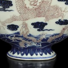 a blue and white vase sitting on top of a table