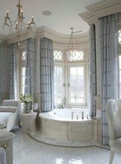 a luxurious bathroom with an oval tub and chandelier