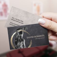 a person holding up a business card with the image of a human torso on it