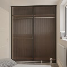 a bedroom with a bed and sliding closet doors