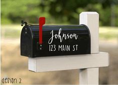 a black mailbox with the words your design here written on it is attached to a white post