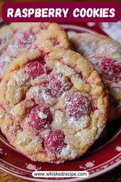 raspberry cookies on a red plate with powdered sugar over the top and bottom