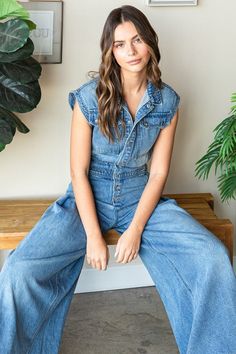 Denim Button Down Sleeveless Jumpsuit Runs very large. We recommend sizing down 1 to 2 sizes. -Medium washed denim -Collared neck -Button down closure -Sleeveless -Big cargo chest pocket -Ruched waist back -Back pockets -Extra wide pant Handwash Cold 95% Cotton 5% Polyester Model is 5'7" and wearing size Small 95% Cotton, 5% Polyester Denim Cap, Collared Top, Denim Button Down, Free People Movement, Washed Denim, Wide Pants, Sleeveless Jumpsuits, Denim Jumpsuit, Tunic Sweater