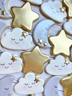 gold and white cookies with stars in the shape of hearts, clouds and smiling faces