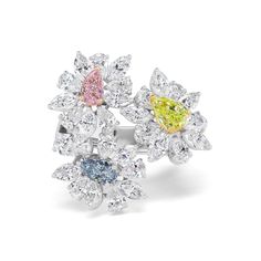 High jewelry meets fun and contemporary with this multi-stone flower ring. White diamonds blossom around Fancy colored diamonds to display a delicate, sculptural look crafted to stand out. 0.31CT Pear Shape Fancy Pink Diamond - SI1 Clarity, GIA#5211317622 0.34CT Pear Shape Fancy Blue Diamond - SI2 Clarity, GIA#2171888908 0.78CT Pear Shape Intense Yellow Green Diamond - SI2 Clarity, GIA# 2171459074 4.68CT Pear Shape and Marquise Natural White Diamonds Luxury Elegant Multi-stone Flower Ring, Luxury Multi-stone Diamond Ring, Fancy Color Diamond Ring, Colored Diamond Jewelry, Colored Diamond Rings, 2024 Color, Green Diamond, Diamond Shop, Fancy Color Diamonds