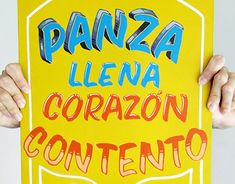 a person holding up a sign that says panza llenna coran conteno