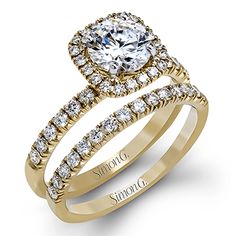 a yellow gold engagement ring set with two rows of diamonds