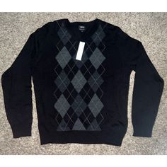 Elevate Your Wardrobe With This Classic And Preppy Apt.9 Men's Sweater. The Black Wool Blend Fabric Features An Argyle/Diamond Pattern, Tight-Knit Construction, And A V-Neckline. The Long Sleeves Make It Suitable For Cooler Weather, While The Collarless Design And Breathable Fabric Make It Comfortable For Year-Round Wear. This Sweater Is Machine Washable, Making It Easy To Care For. Its Regular Fit And Size L Make It A Versatile Addition To Any Wardrobe. Perfect For Casual Occasions, This Pullov Black Cotton V-neck Sweater, Black V-neck Cotton Sweater, Black Cotton V-neck Winter Sweater, Black Cotton V-neck Sweater For Winter, Cooler Weather, Wool Blend Sweater, Black Wool, Diamond Pattern, Men's Sweater