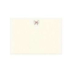 a white card with a red bow on it