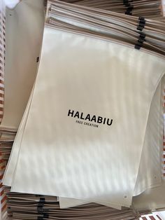 several sheets of paper stacked on top of each other with the word haalaabu printed on them