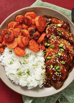 a plate with rice, meat and vegetables on it