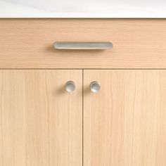 a cabinet with two doors and knobs on it