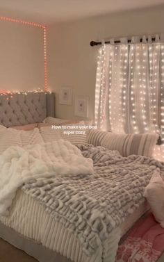 a bed with lights on the headboard and pillows