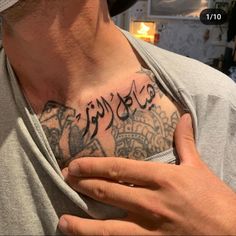 a man with arabic writing on his chest