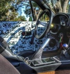 the interior of a car with wood dash board and steering wheel in front of it