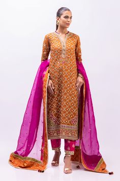 This marori work orange cotton net kurta has bright pops of fuschia pink and turquoise detailings. It is paired with a bright pink brocade shalwar detailed with zardoze and a kamdani organza dupatta. Pink Tissue Silk Churidar With Straight Kurta, Pink Tissue Silk Churidar For Diwali, Festive Tissue Silk Dupatta With Naqshi Detailing, Anarkali Tissue Silk Kurta With Naqshi Detailing, Pink Cotton Silk Sharara With Dabka Work, Designer Pink Tissue Silk Churidar, Designer Tissue Silk Pink Churidar, Traditional Naqshi Tissue Silk Kurta, Traditional Naqshi Kurta In Tissue Silk