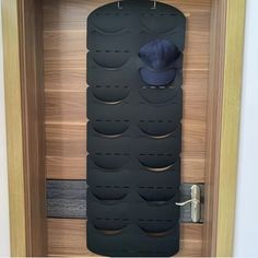 a hat and coat rack in a wooden door