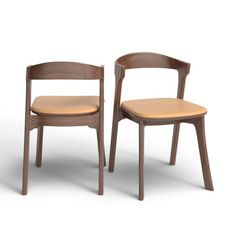 two wooden chairs sitting next to each other on a white surface with no one in it