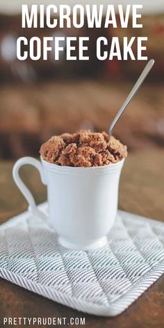 a white mug filled with coffee cake on top of a table