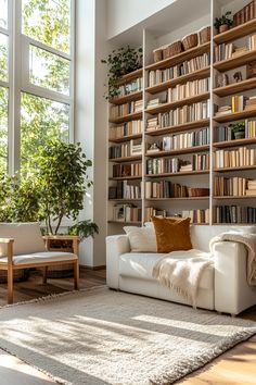 a living room filled with lots of furniture and bookshelves next to a window