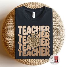 a black t - shirt with an apple and leopard print on it that says teacher teacher